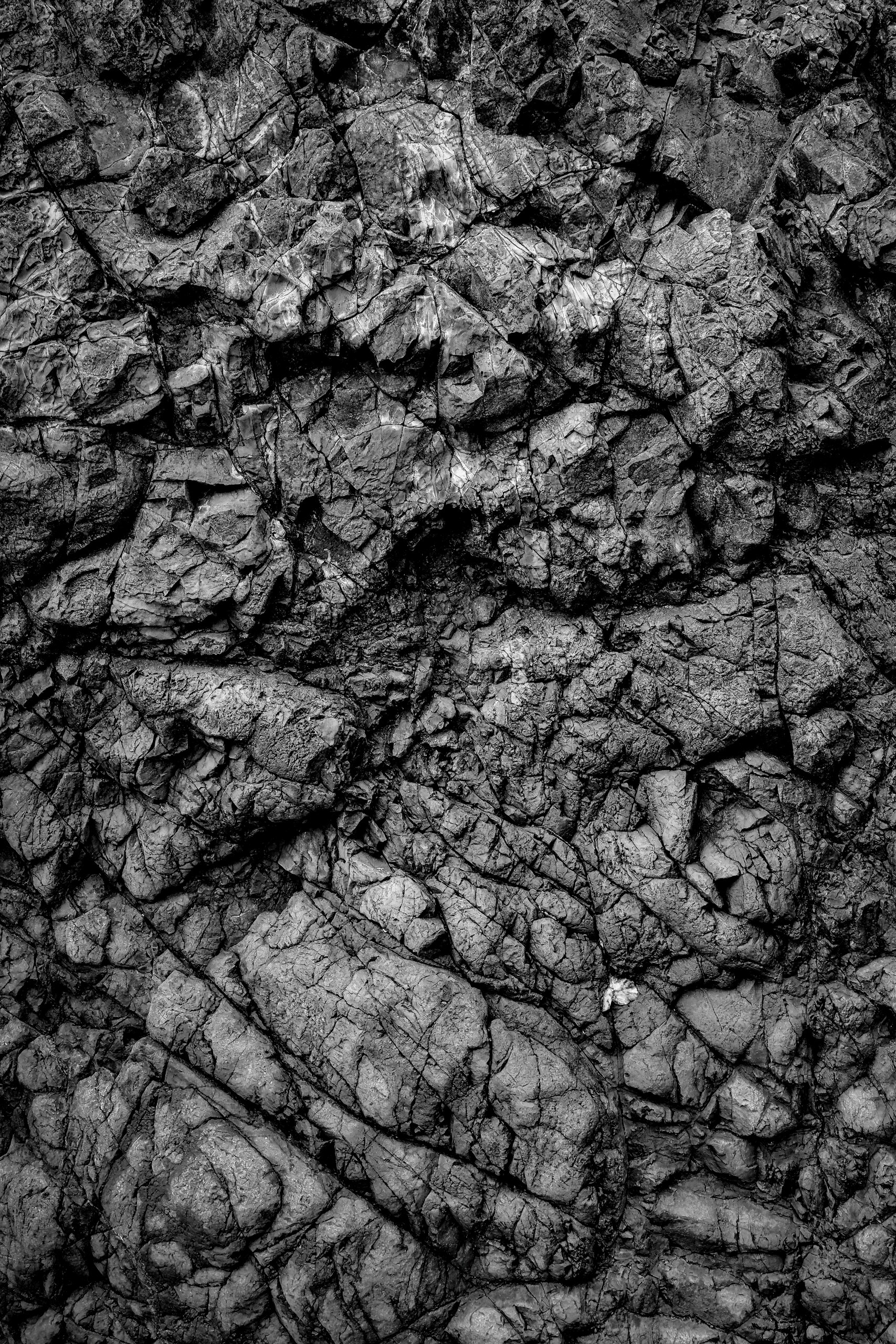 Close-up of rough, deeply fissured stone.